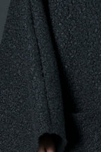 Black bouclé poncho with merino wool-like feel and two front pockets - wear as a top or outer layer, Magdalena | EUG Fashion #black
