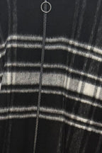 Close-up of a black and white striped garment with a zipper.