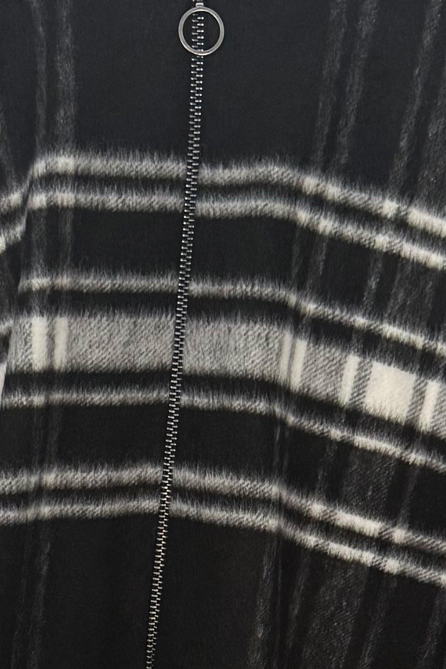 Close-up of a black and white striped garment with a zipper.