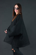 Black bouclé poncho with merino wool-like feel and two front pockets - wear as a top or outer layer, Magdalena | EUG Fashion #black
