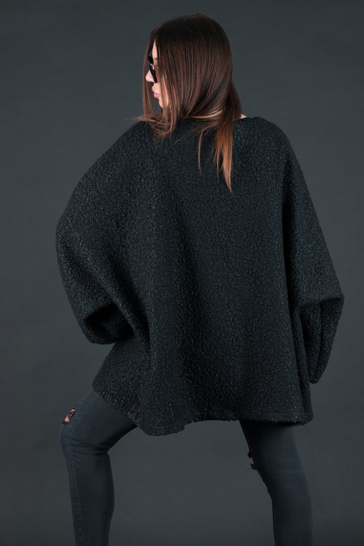 Black bouclé poncho with merino wool-like feel and two front pockets - wear as a top or outer layer, Magdalena | EUG Fashion #black
