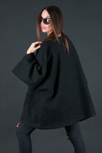 Black bouclé poncho with merino wool-like feel and two front pockets - wear as a top or outer layer, Magdalena | EUG Fashion #black

