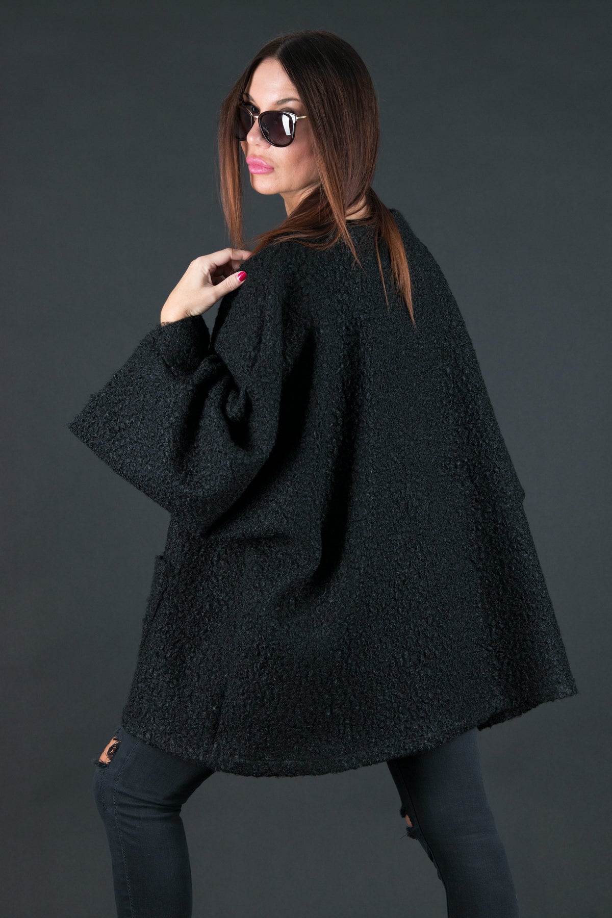 Black bouclé poncho with merino wool-like feel and two front pockets - wear as a top or outer layer, Magdalena | EUG Fashion #black
