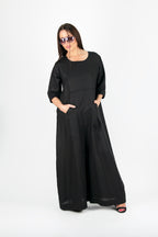 Woman wearing a black jumpsuit with pockets - EUG fashion