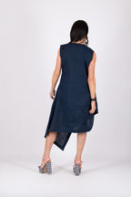 Woman wearing a navy blue sleeveless dress on a white background