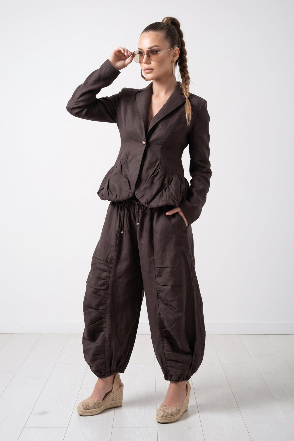 Woman wearing a brown jumpsuit on a white background