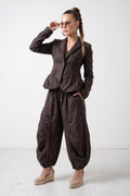 Woman wearing a brown jumpsuit on a white background