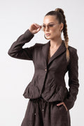 Woman wearing a brown jumpsuit on a white background