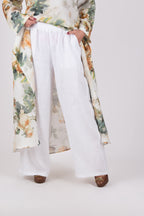 Person wearing a white linen loose fit pants - EUG fashion