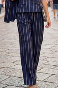 A person wearing navy blue pinstripe trousers 