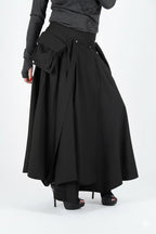 Black skirt worn by a person on a white background