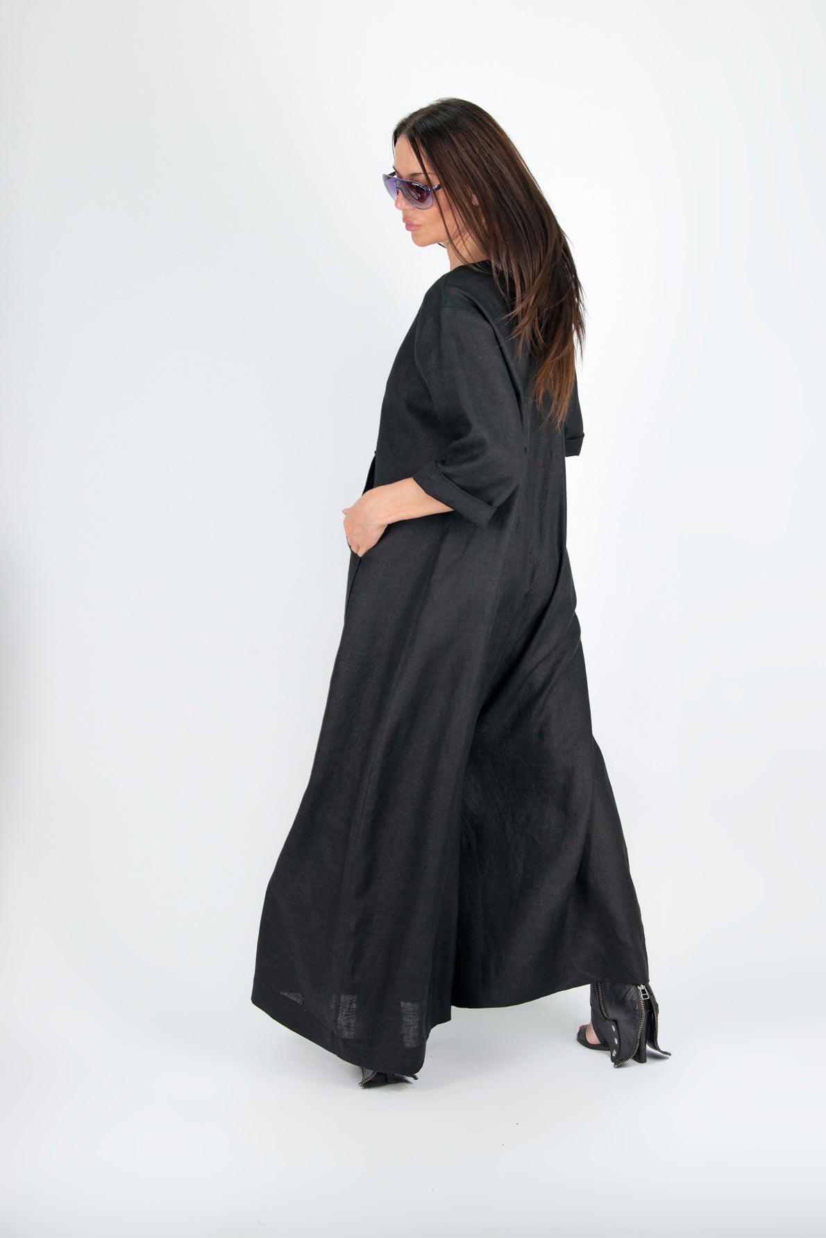 Woman wearing a long black dress on a white background