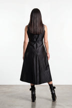 Woman wearing a black dress with a white background
