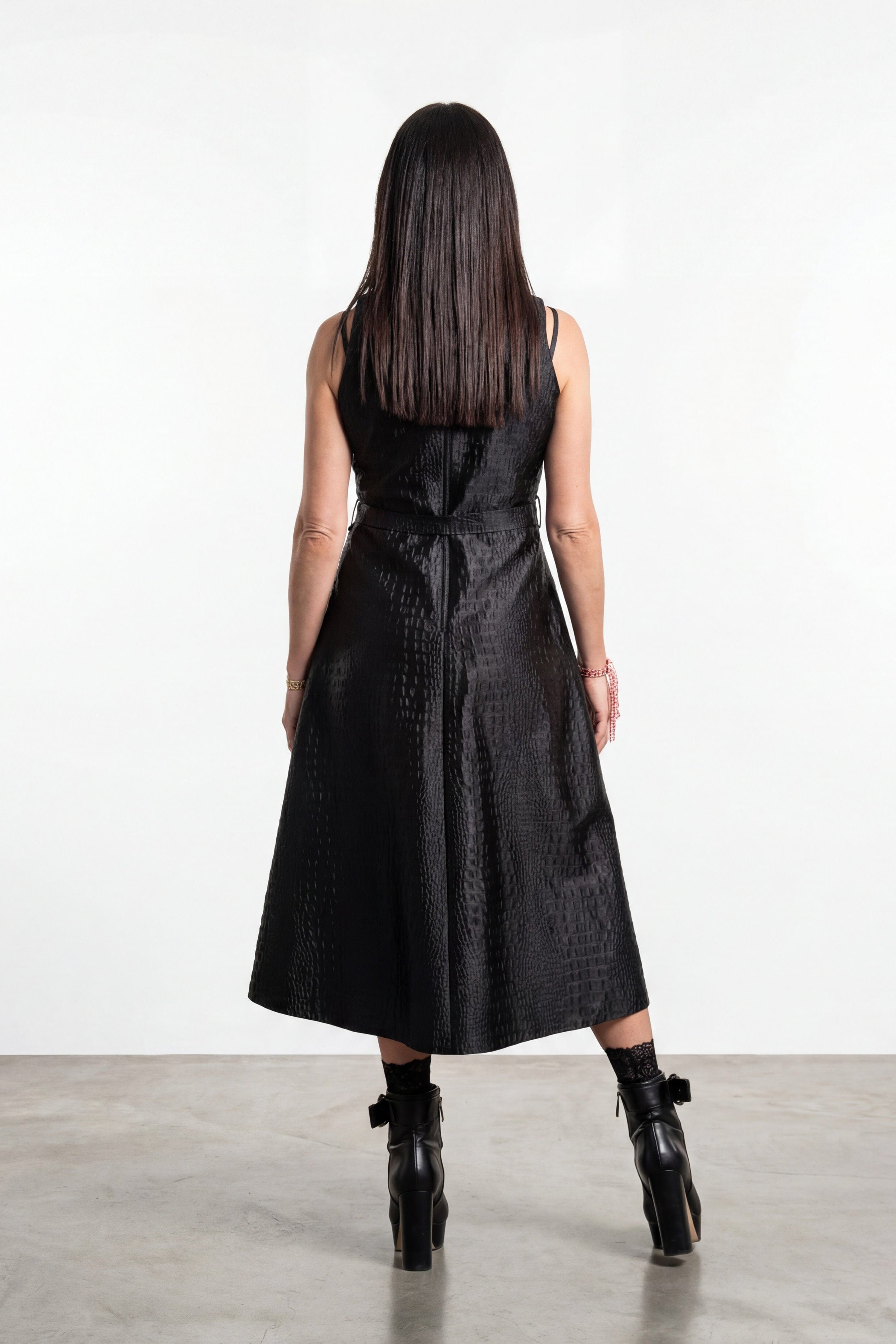 Woman wearing a black dress with a white background
