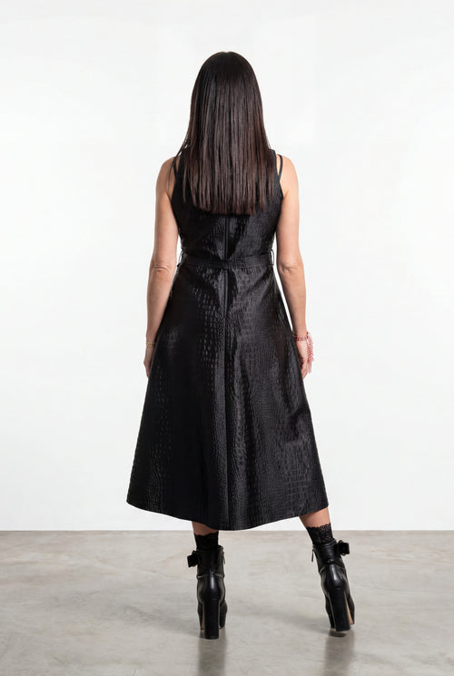 Woman wearing a black dress with a white background
