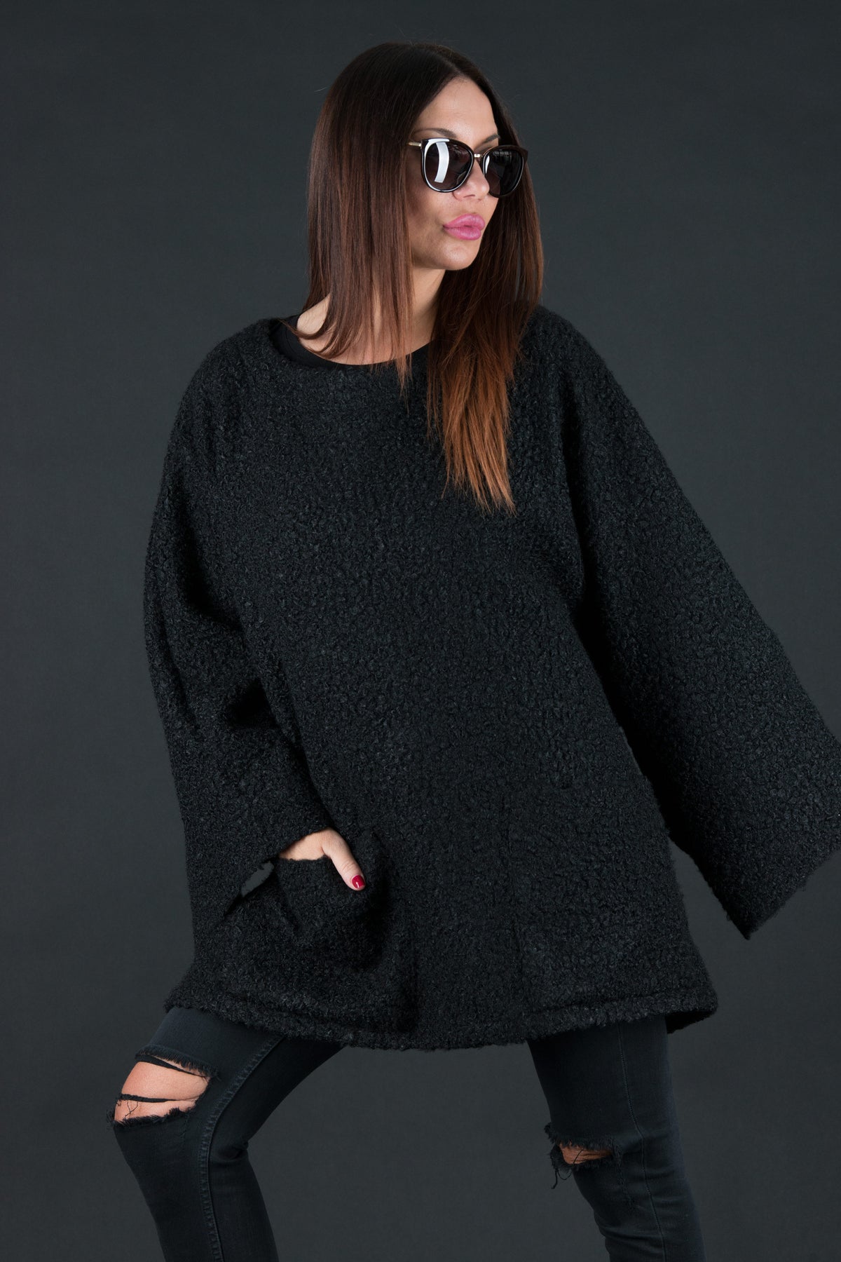 Black bouclé poncho with merino wool-like feel and two front pockets - wear as a top or outer layer, Magdalena | EUG Fashion #black
