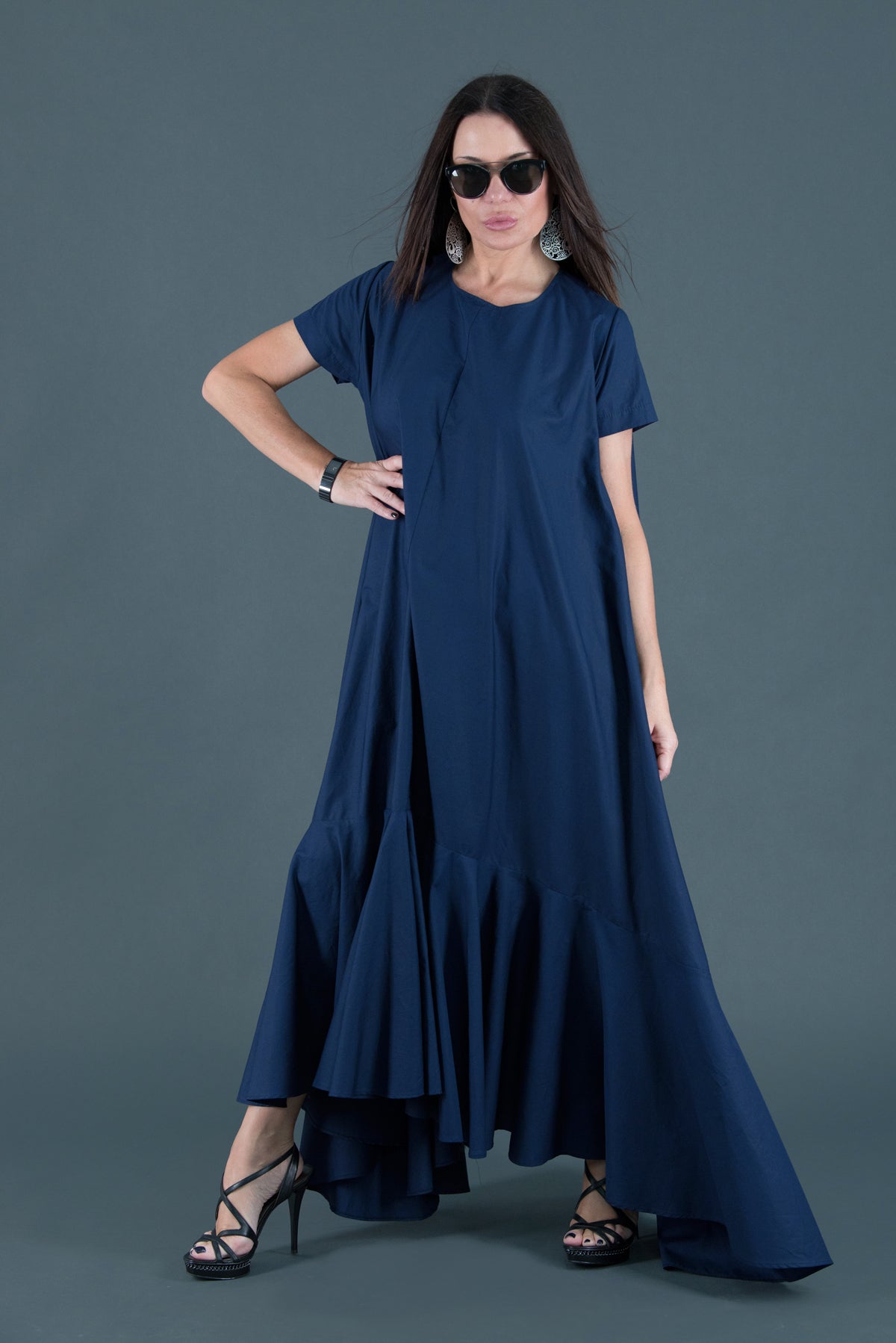 Woman wearing a blue dress against a gray background