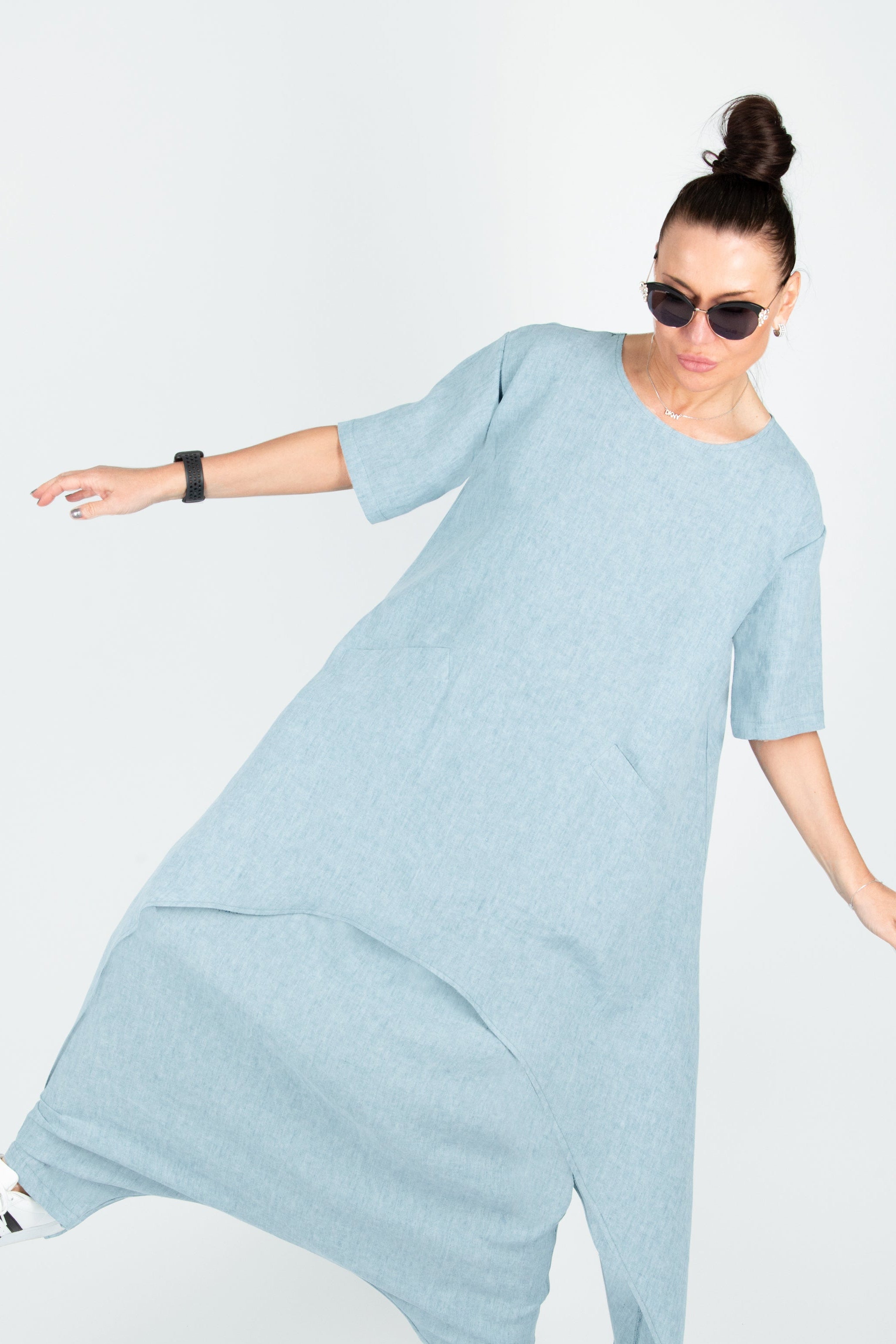 Woman wearing a light blue dress on a white background