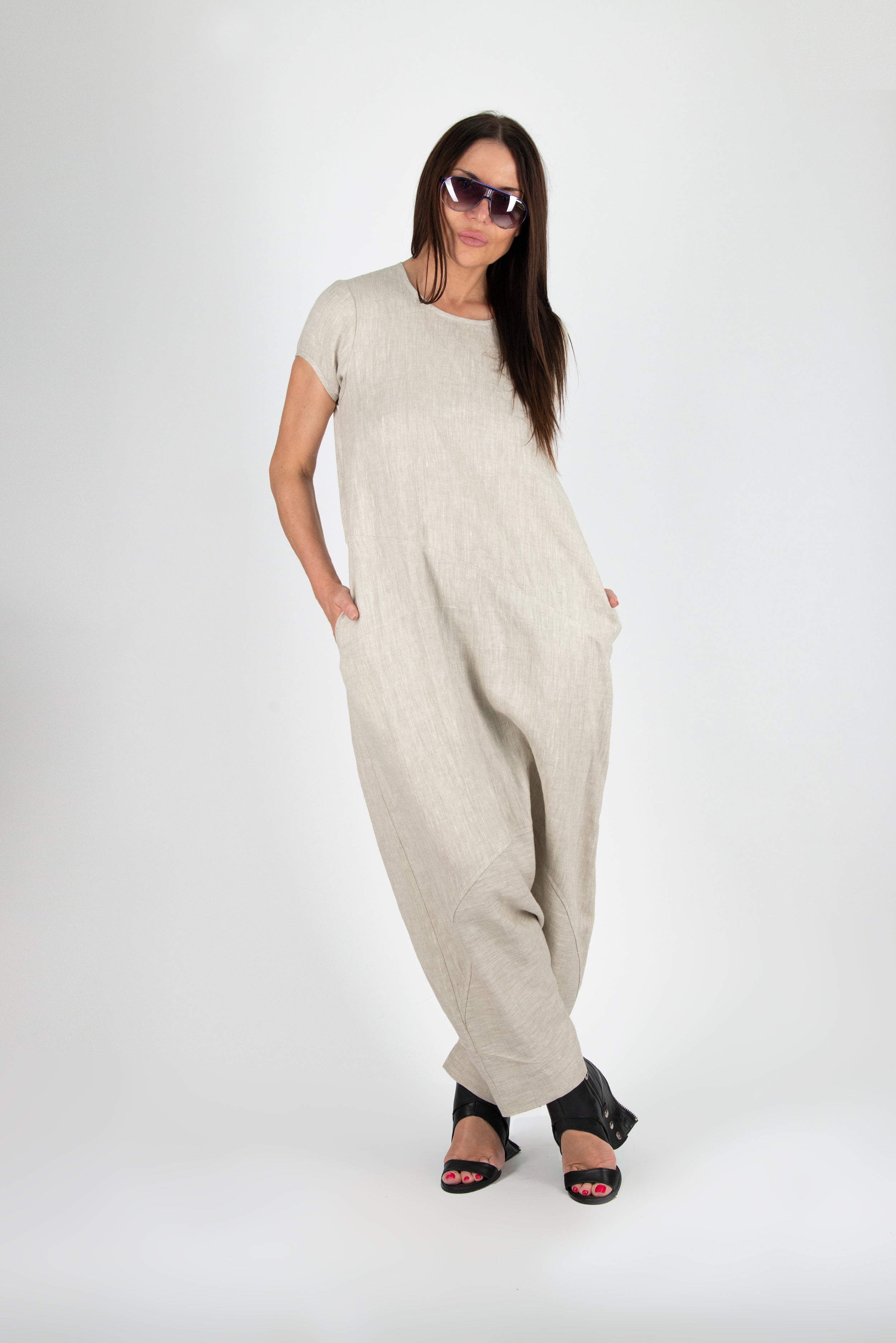 Woman wearing a beige jumpsuit on a white background