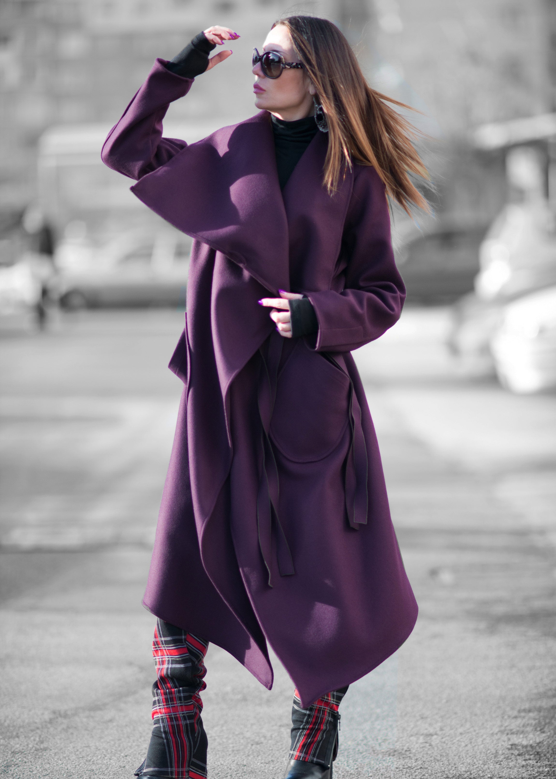 Woman wearing a purple coat on a street