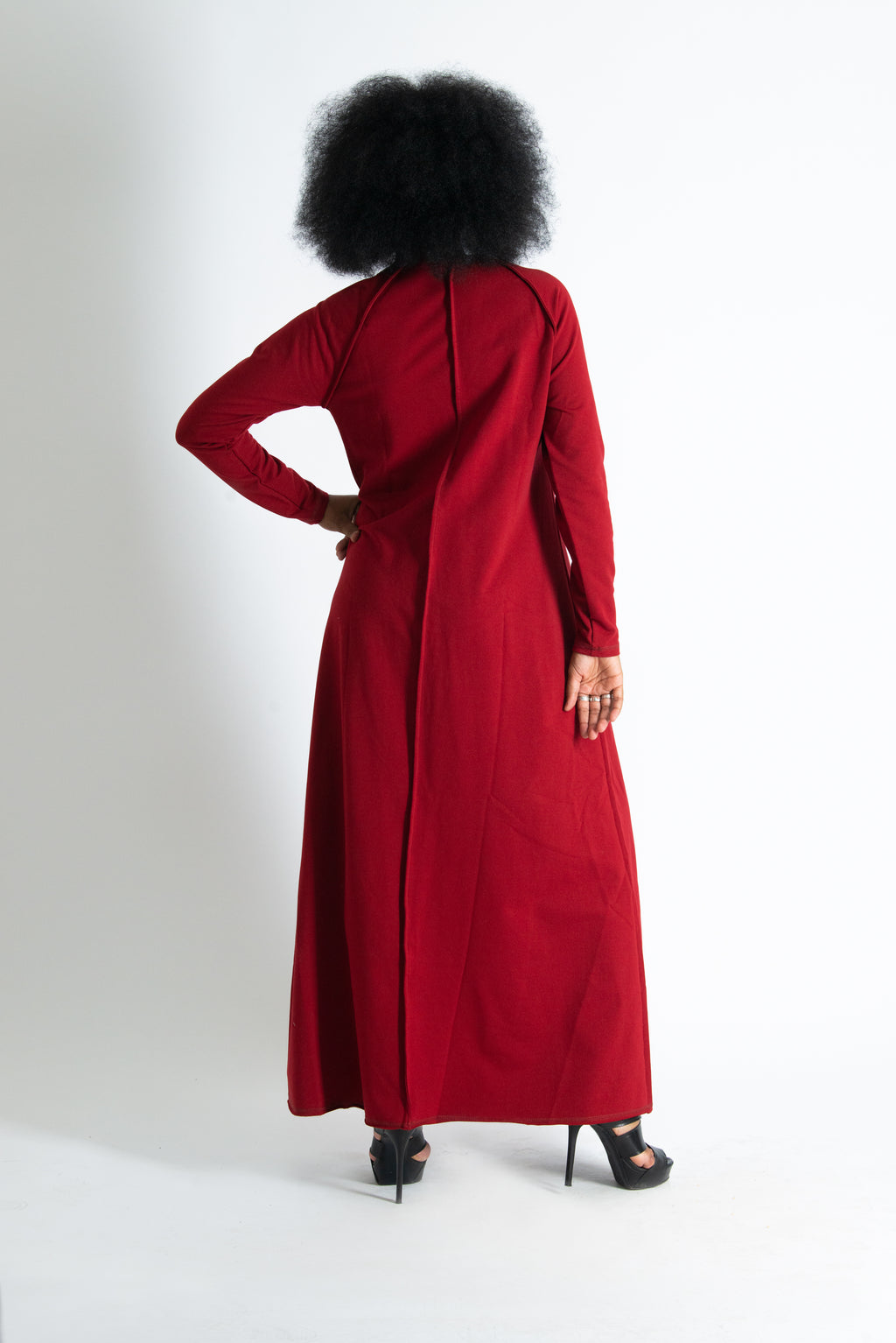Person wearing a red dress with a plain background