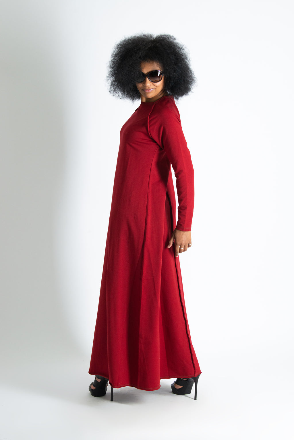 Woman wearing a long red dress on a white background
