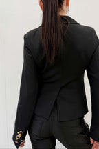 Person wearing a black blazer from behind on a white background