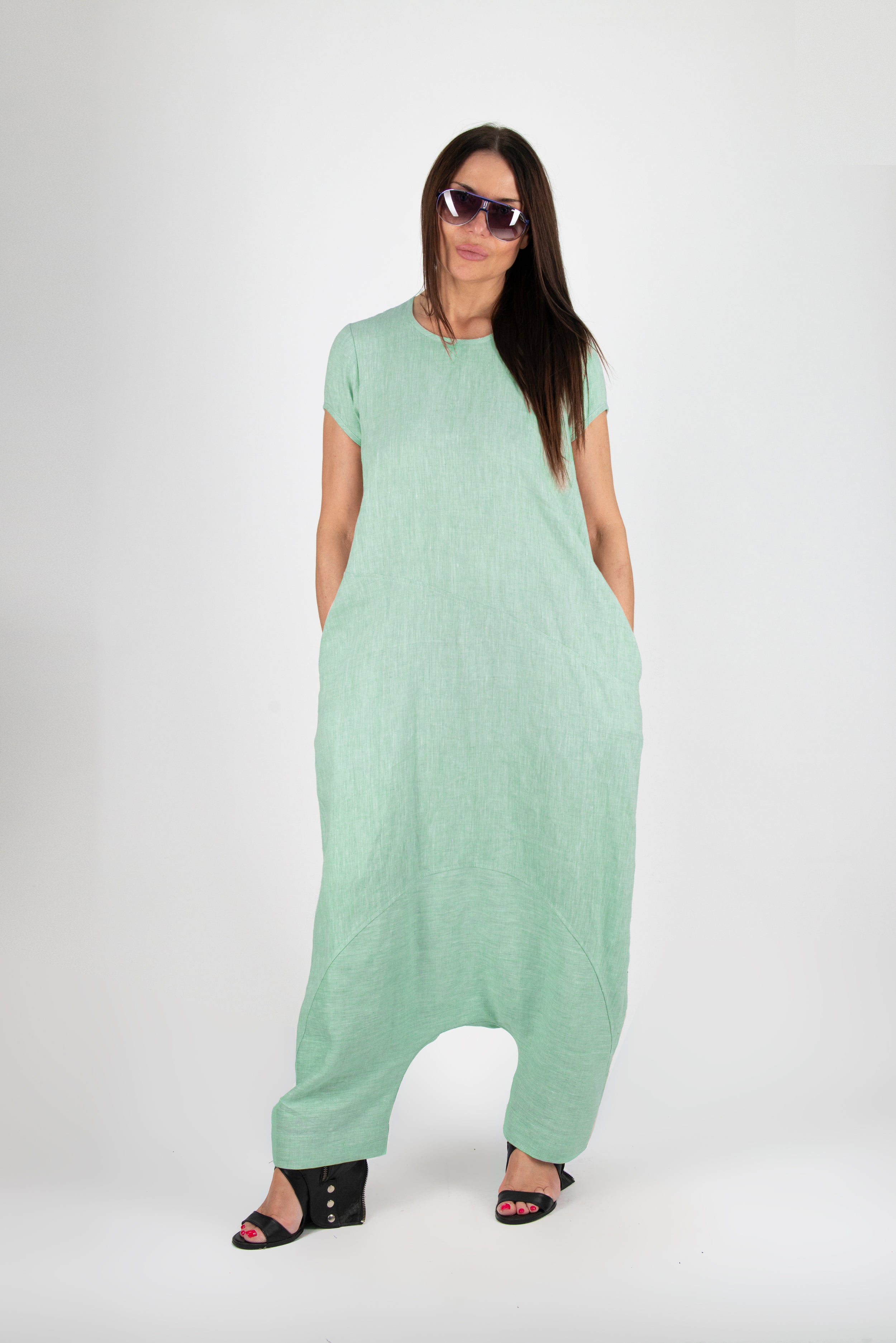 Woman wearing a light green dress with a plain background