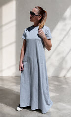 Woman wearing a long gray dress with 