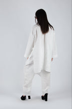 Person wearing a white outfit on a plain background