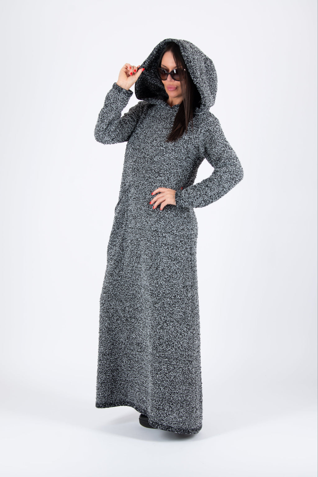 Person wearing a long gray hooded dress on a white background