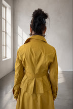 Person wearing a yellow trench coat 