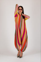 Woman wearing a colorful, patterned outfit on a white background
