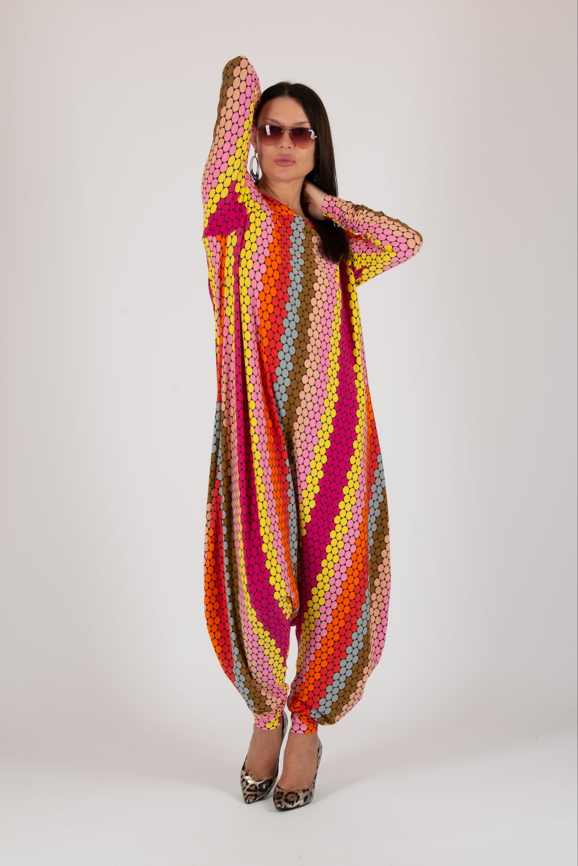 Woman wearing a colorful, patterned outfit on a white background