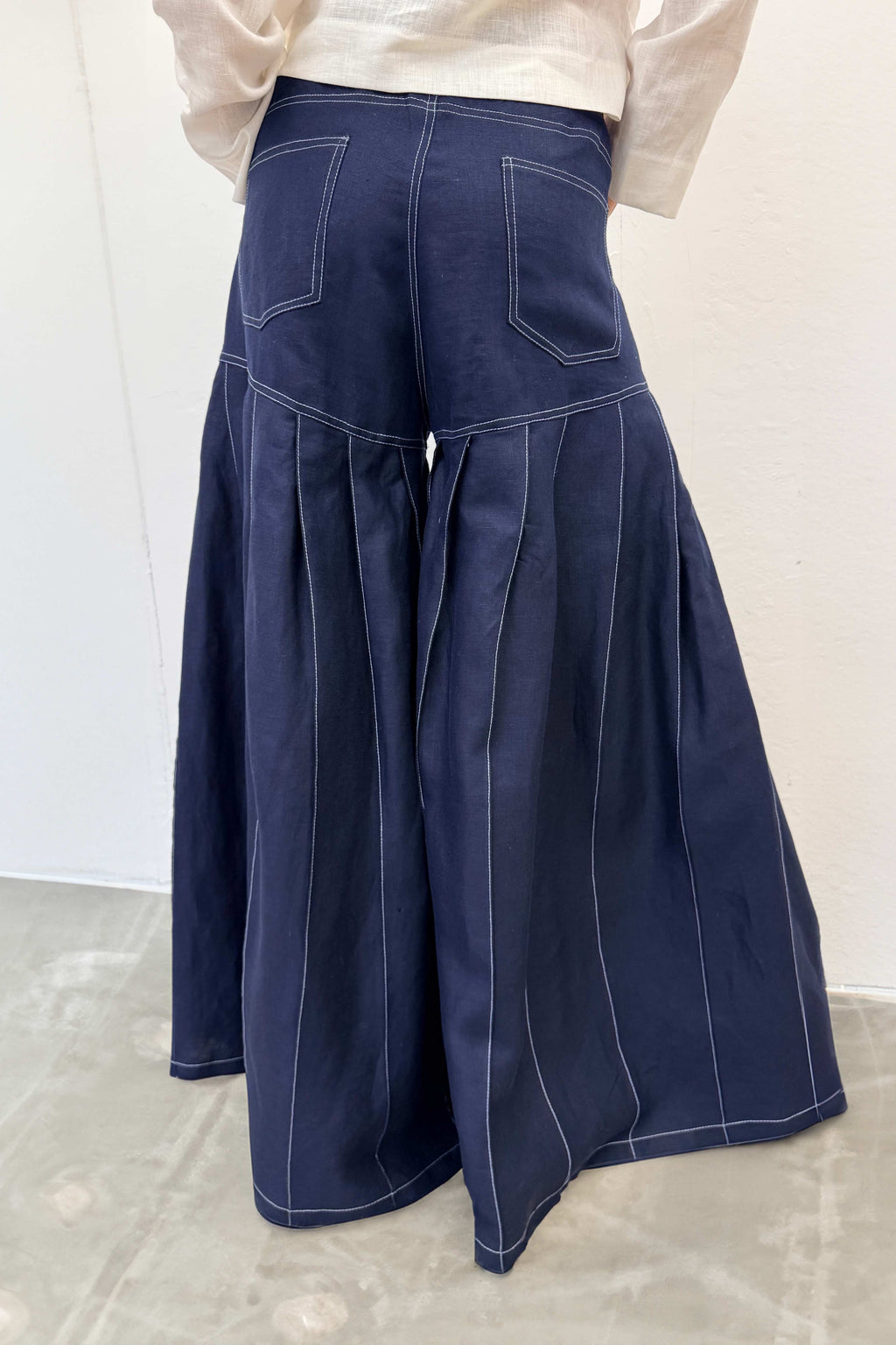 Navy blue wide-leg pants on a plain background