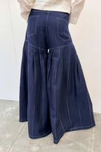Navy blue wide-leg pants on a plain background