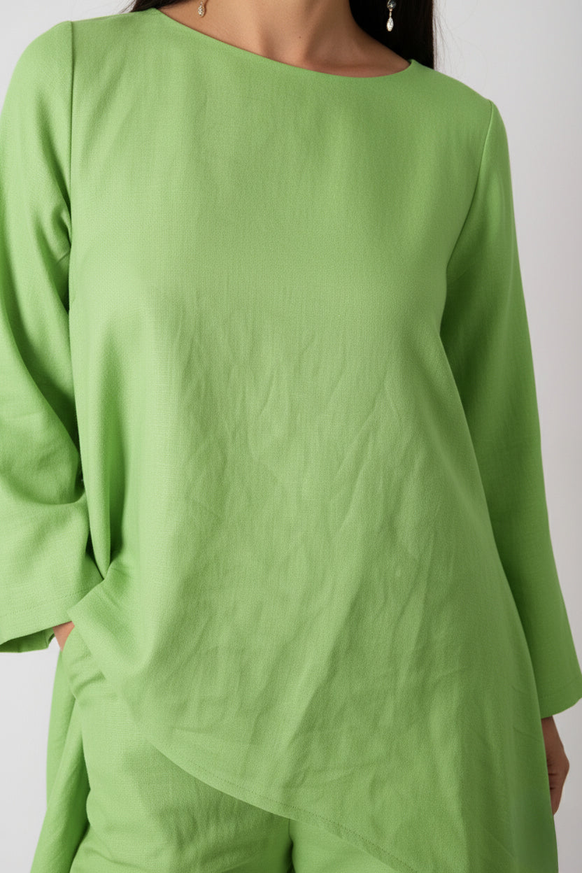 Green outfit with long sleeves on a plain background