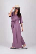 Woman wearing a long purple jumpsuit with hoode