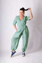 Woman wearing a green jumpsuit on a white background