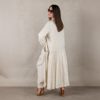 Woman wearing a long, light-colored linen vest EugFashion 