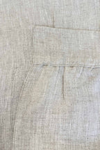 Close-up of beige fabric with a pocket detail