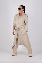Woman wearing a beige outfit with a shirt and pants on a white background