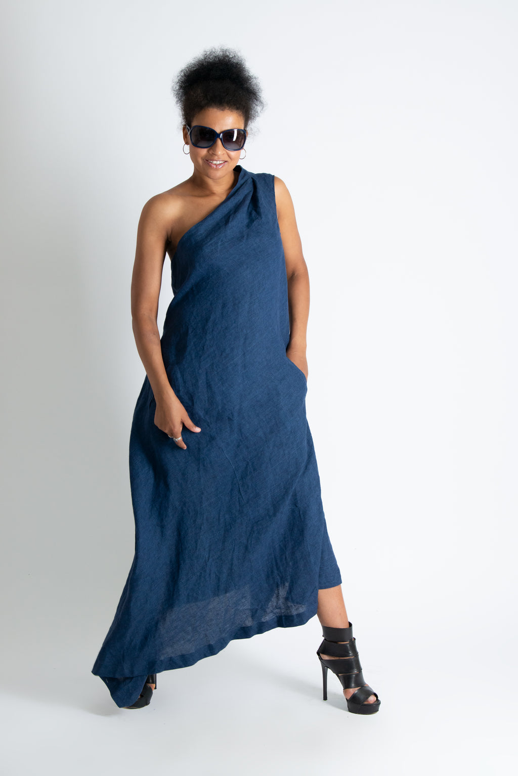 Woman wearing a blue one-shoulder dress on a white background