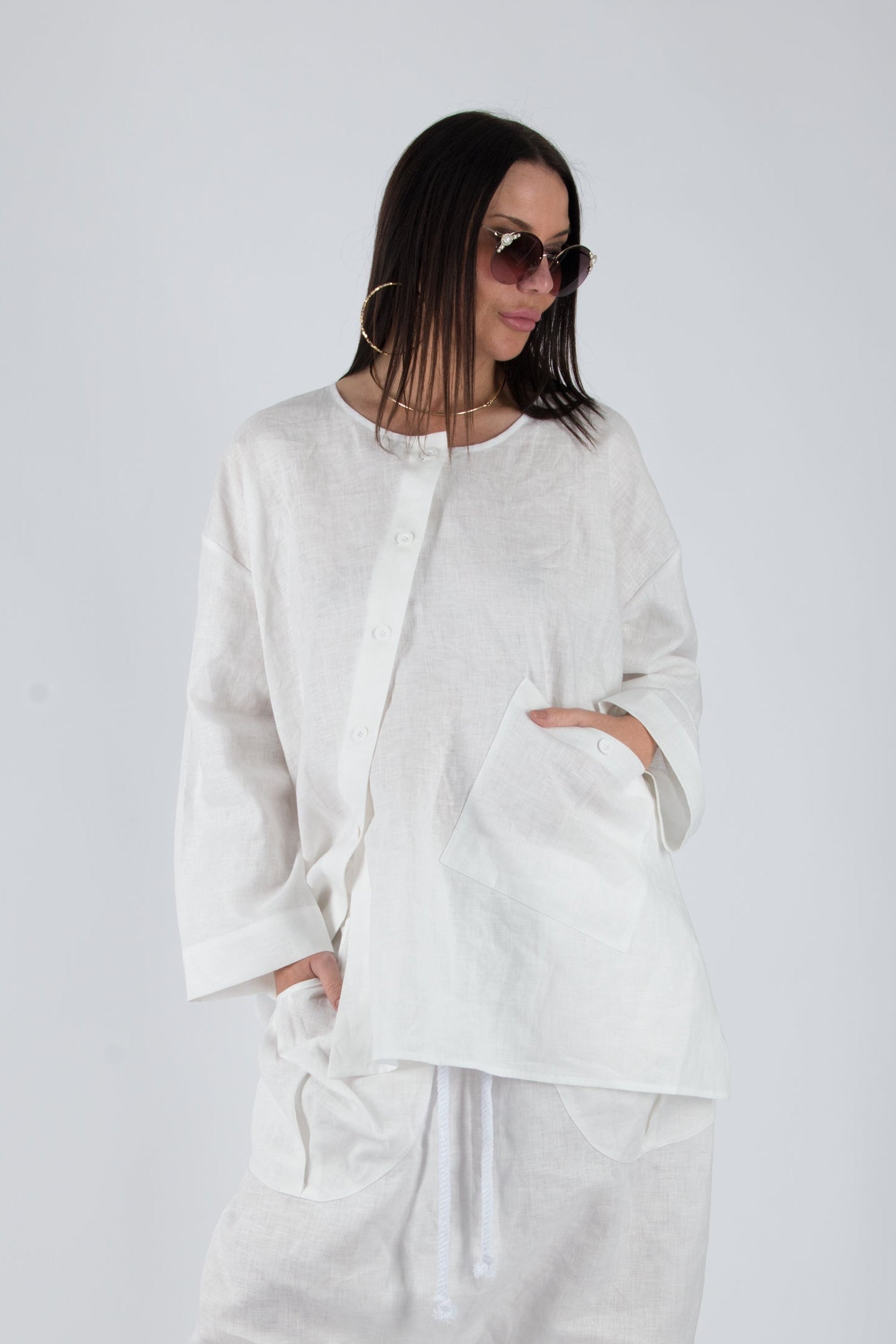 Person wearing a white outfit on a plain background