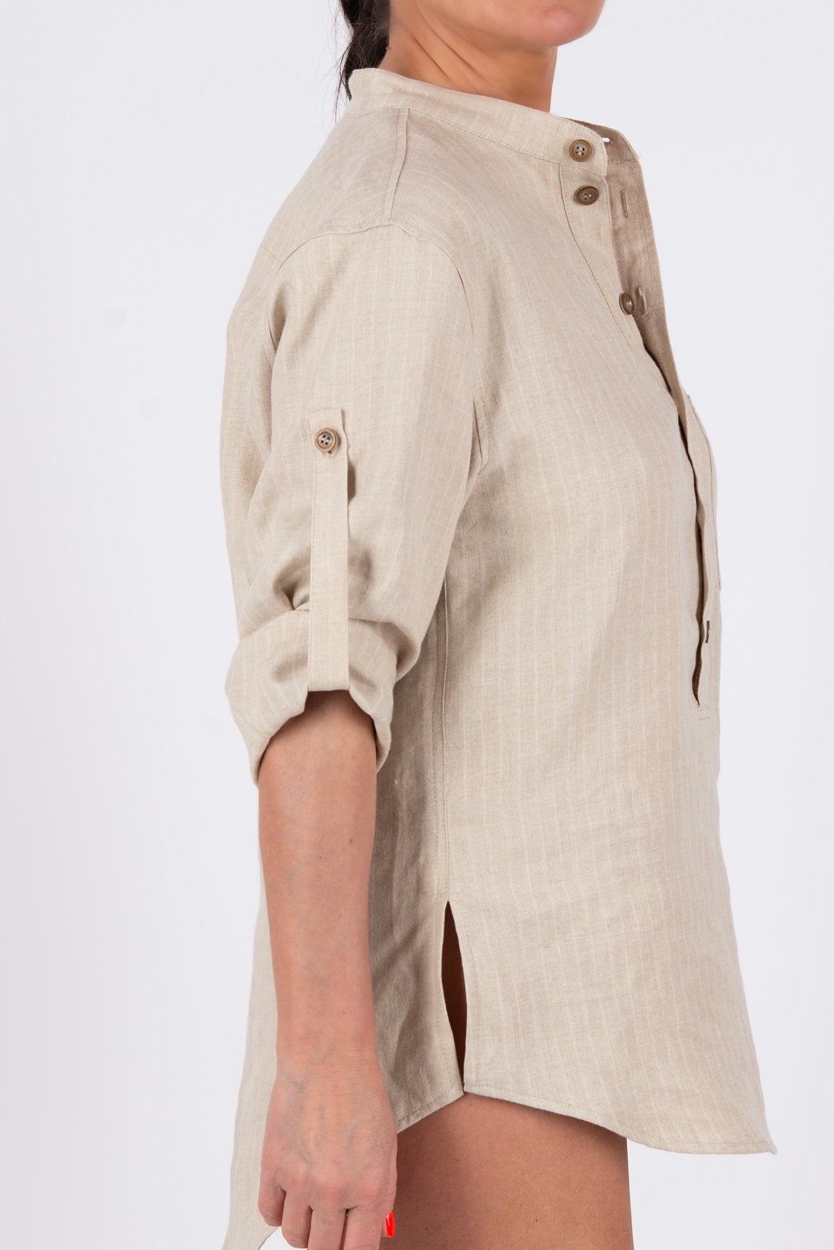 Beige linen shirt with rolled-up sleeves on a white background