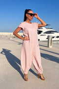 Woman in a pink linen jumpsuit - EUG fashion