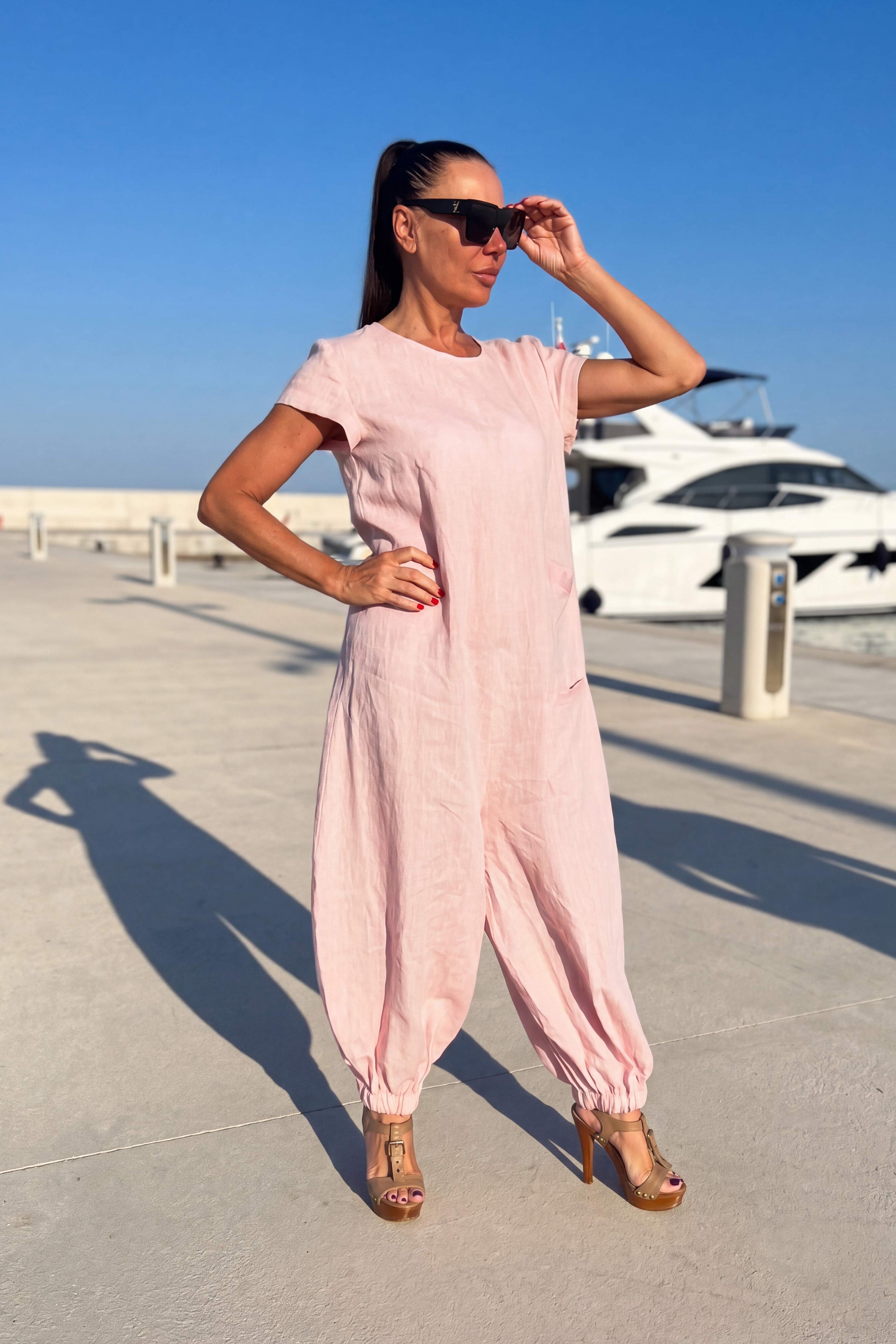 Woman in a pink linen jumpsuit - EUG fashion