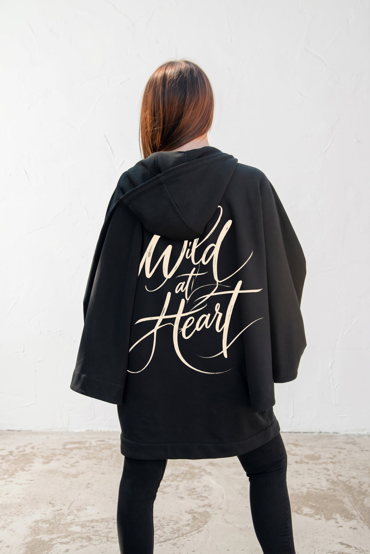 Black hooded poncho sweatshirt - batwing sleeves, snap-fastening pockets and Wild at Heart back print, Melody | EUG Fashion #black