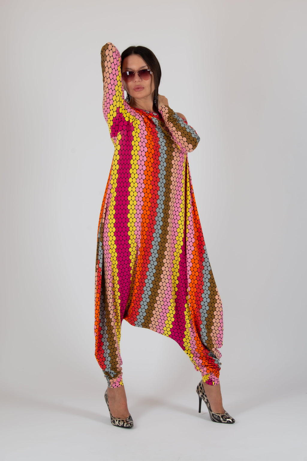 Person wearing a colorful, patterned outfit on a white background