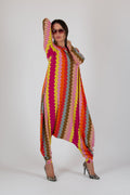 Person wearing a colorful, patterned outfit on a white background